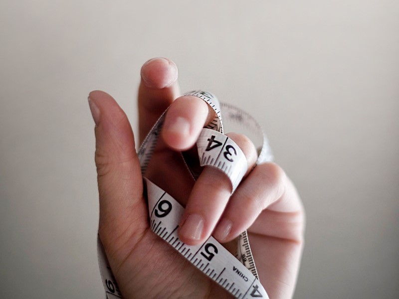 Hand holding a tape measure