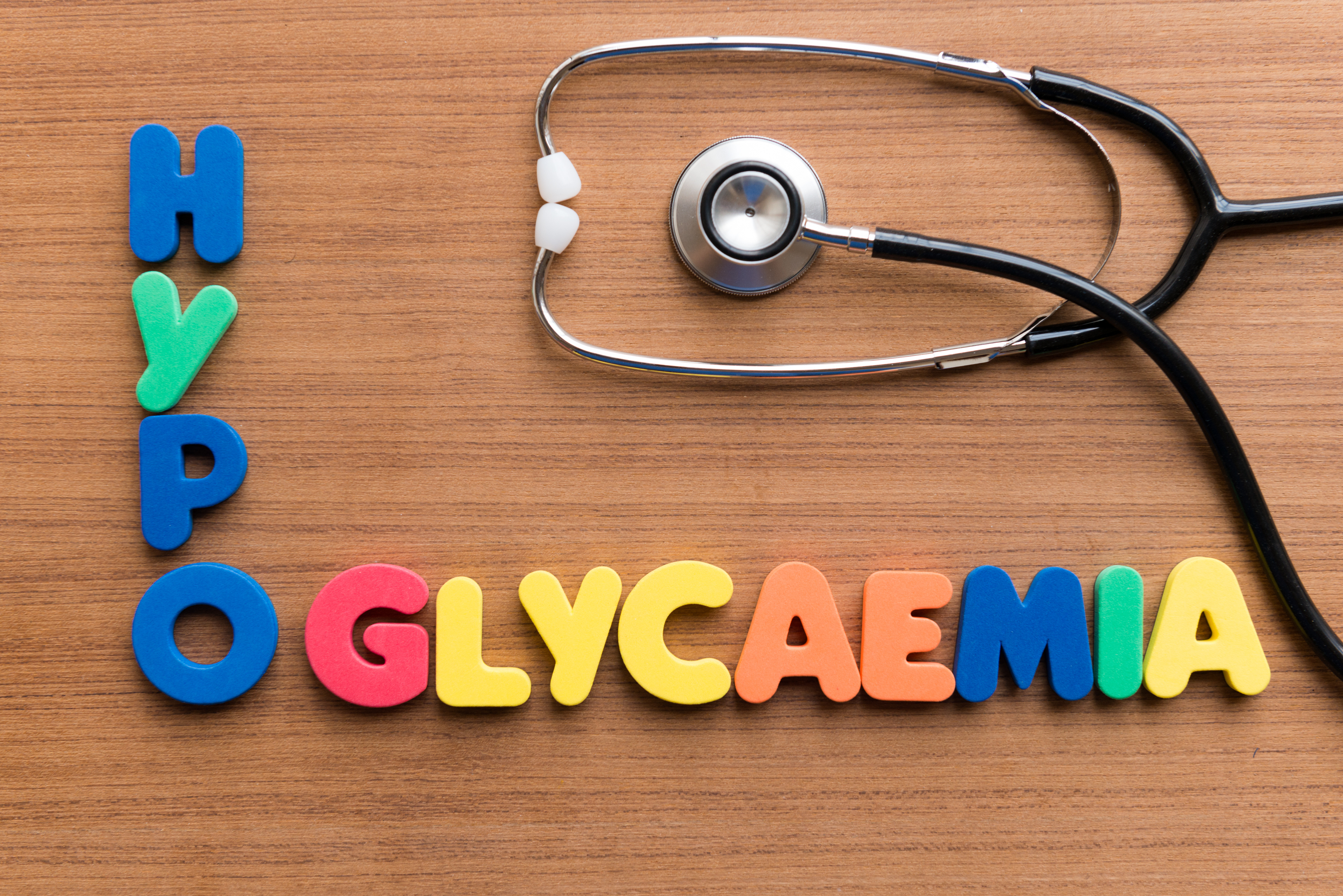 Hypoglycaemia colourful word on wooden background
