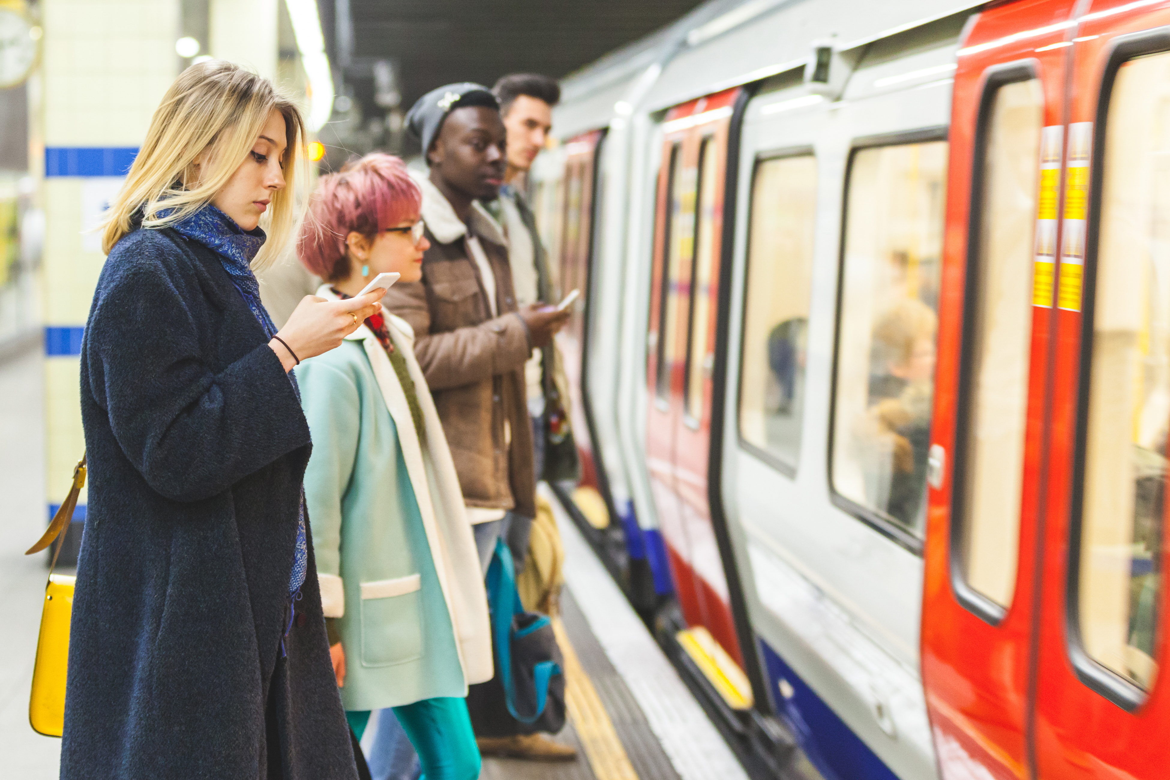 Young woman using a smartphone in the subway