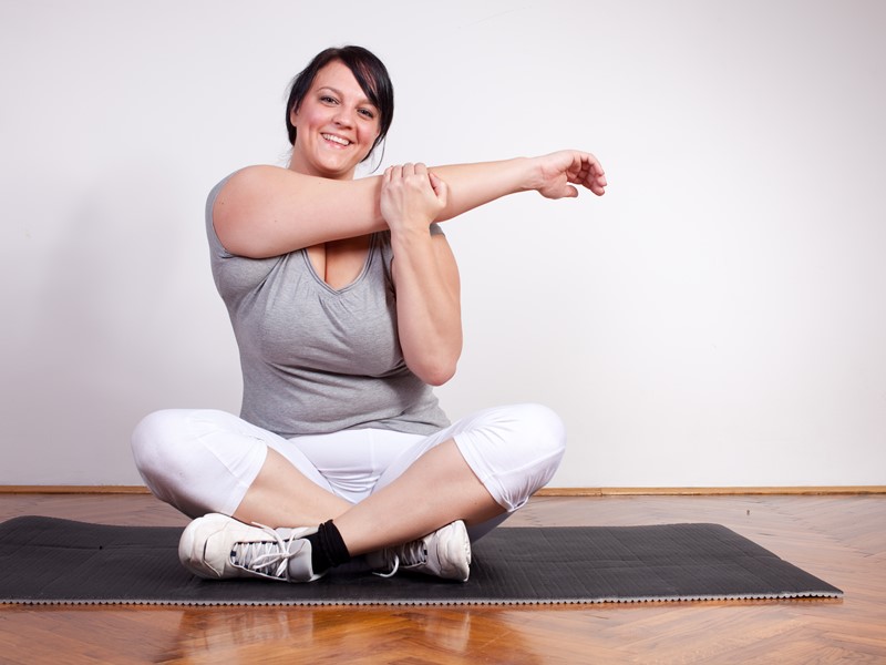 Woman stretching on yoga mat
