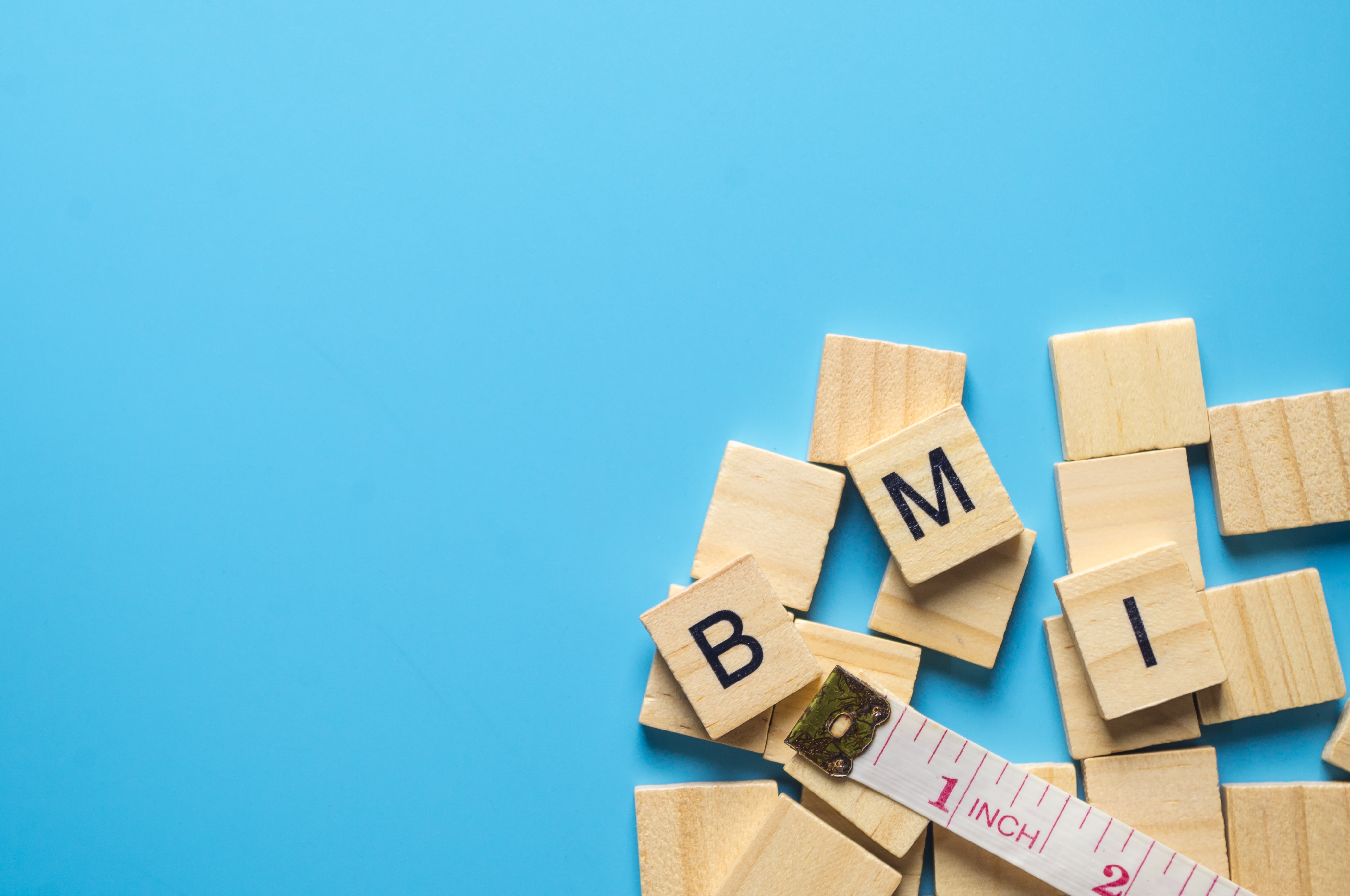 Letters BMI written on small wooden squares