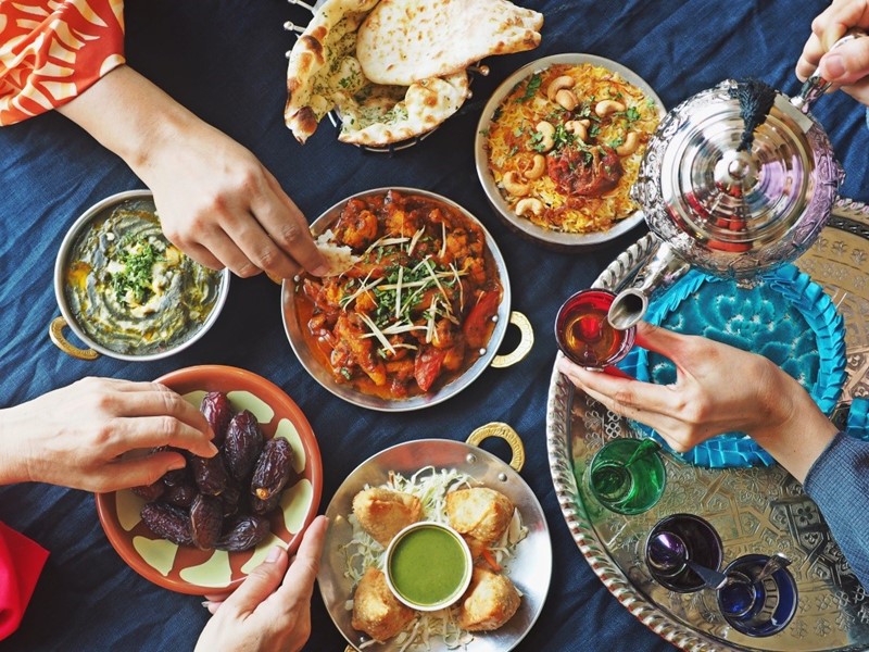 People gathered round table eating to break the fast